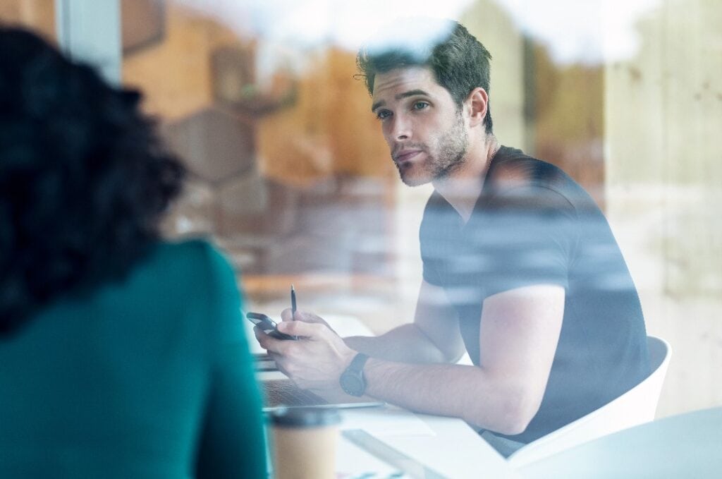 Successful business team working together while talking with laptop in coworking place.